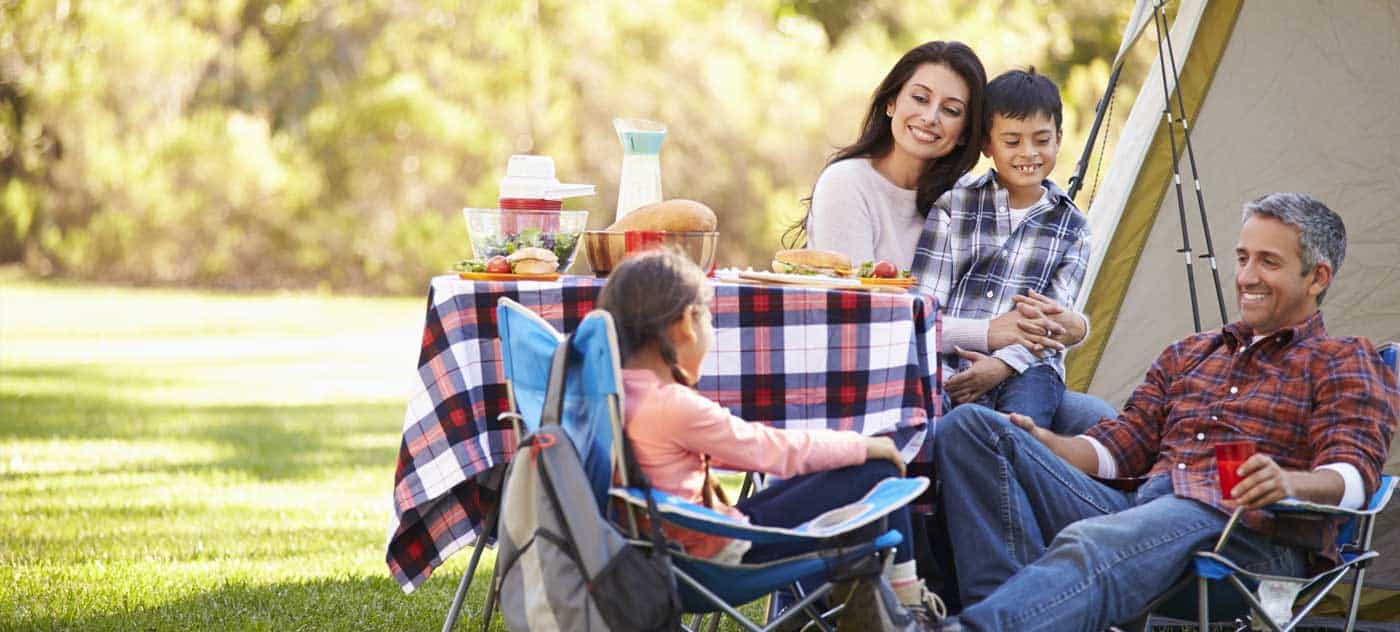 Family enjoying a picnic at the Pigeon River Campground near Gatlinburg