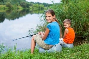 Sister and brother going fishing on their Smoky Mountain camping trip.