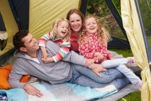 Happy family having fun in their tent while camping in the Smoky Mountains in spring.