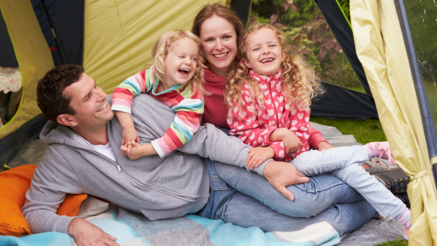 Happy family having fun in their tent while camping in the Smoky Mountains in spring.