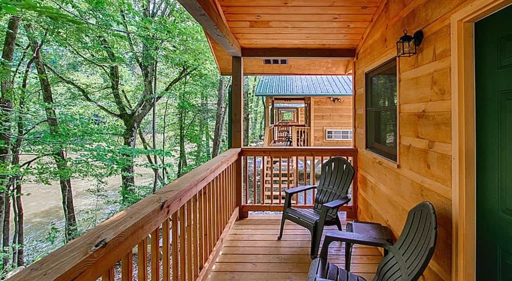 A porch overlooking the river at a cabin at Pigeon River Campground.