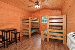 Beds and a table inside a cabin at Pigeon River Campground.
