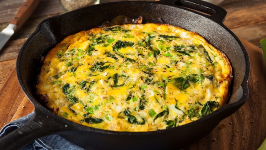 vegetable frittata in a cast iron skillet on a table